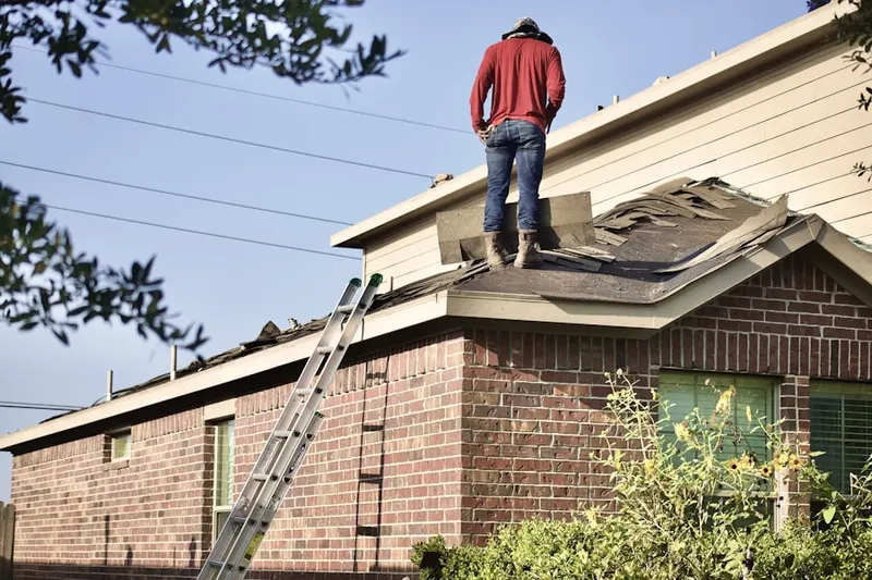 Professional roofer working on a residential roof in Hathorne